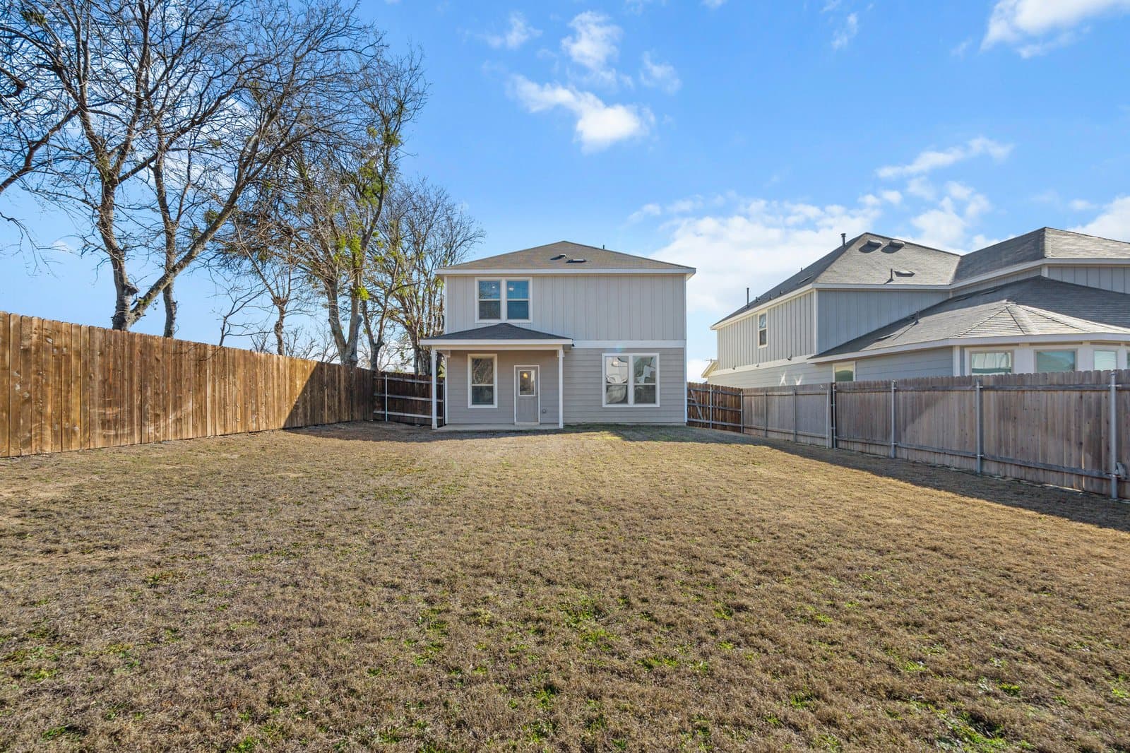Backyard with brown winter grass