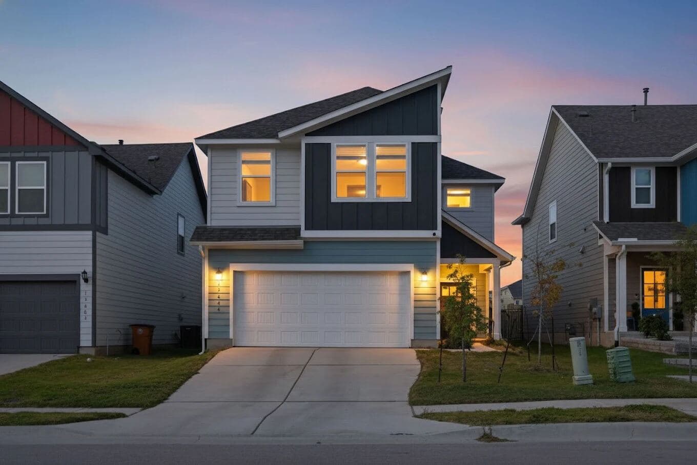 Craftsman home at twilight with warm lights on